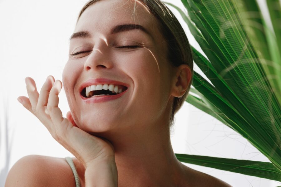 Close-up of a smiling patient showcasing a natural-looking smile after dental crown treatment, highlighting restored strength, beauty, and confidence – dental crown